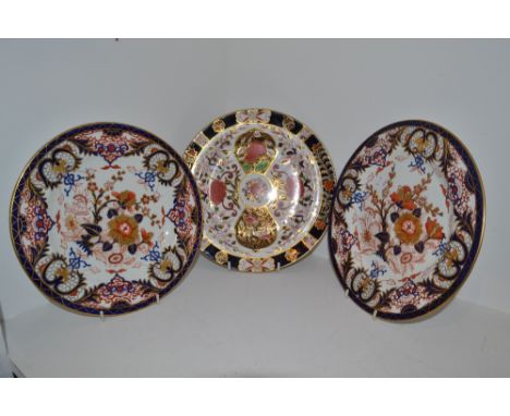 A pair of Derby Imari circular plates, decorated with stylised foliage, crown, crossed batons and D mark in red, c.1800;  ano