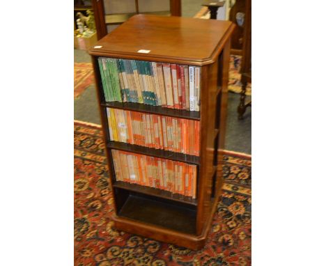 A Victorian walnut canted square revolving bookcase, skirted base, ceramic casters, c.1880