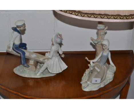 A Lladro figure, Boy and Girl on a seesaw, a Lladro lamp the base modelled as a girl sat with a dove (2)