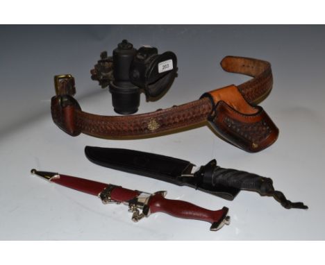 A decorative WWII style German blade and scabbard, others, a leather belt and pistol holder, a vintage car headlamp (5)