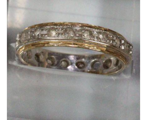 18ct gold eternity ring.  3.1g approx.  Missing one stone (not diamonds).   (B.P. 21% + VAT) 