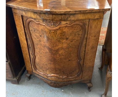 Burr walnut bow front single door blind panelled cabinet, the interior revealing fitted shelf standing on shaped feet. 84x53x