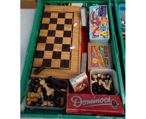 Box of games and game pieces to include: a chess board, chess pieces, checkers pieces, dominoes, jigsaw puzzle, playing cards