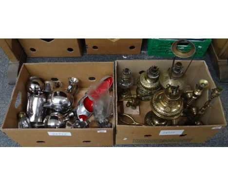 Two boxes of metalware to include: brass candlesticks, lamp base, oil lamp bases, a football trophy, plated tea and coffee wa