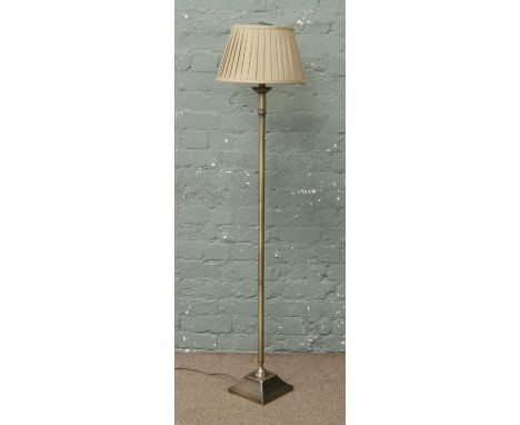 A brushed brass effect standard lamp.