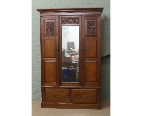 A Victorian carved mahogany double wardrobe.