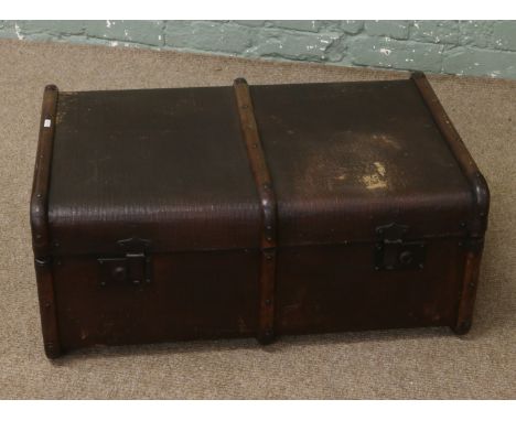 A vintage canvas and wood bound travelling trunk.