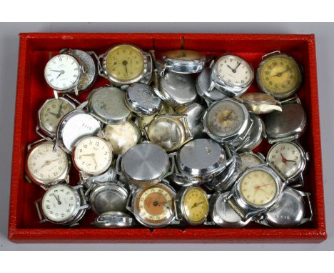 A large collection of vintage watch heads, mainly manual.