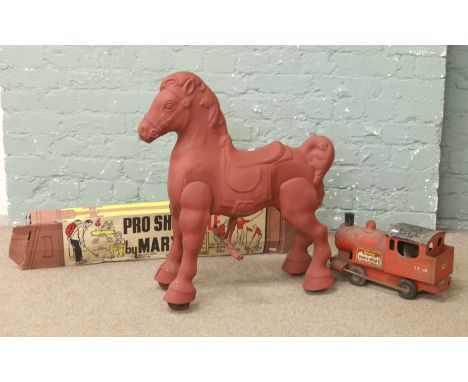 A group of vintage toys including a Triang puff puff locomotive, tin plate mobo rocking horse and a boxed pro shot golf game 