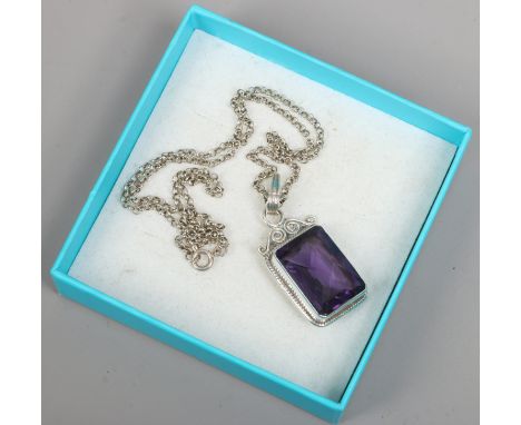 A silver pendant set with a faceted hardstone on silver chain.