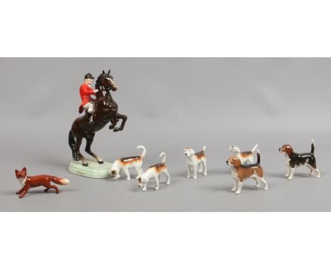 An eight piece Beswick fox hunting set to include beagles, fox hounds and the fox, along with a huntsman on a rearing horse (