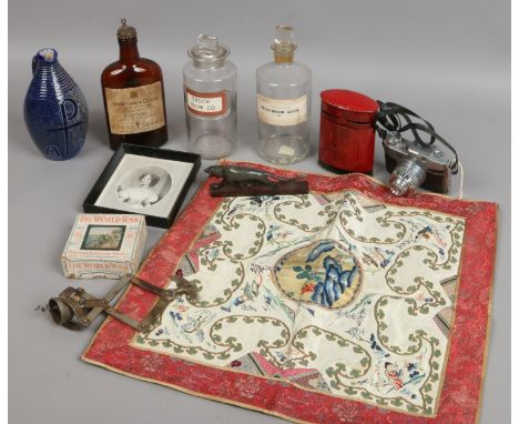 A box of collectables including apothecary bottles, scissors action corkscrew and World War Primus lantern slides.