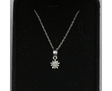 A sterling silver diamond cluster pendant on chain.