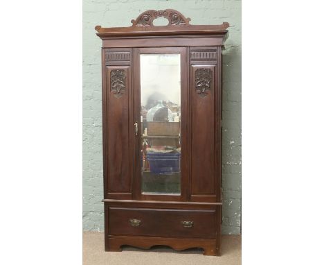 A Victorian carved mahogany mirror front wardrobe.