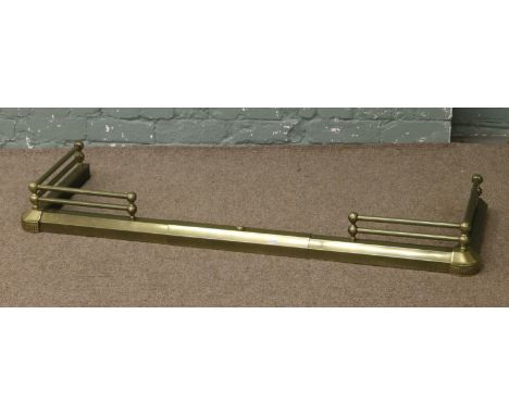 A Victorian brass adjustable fire fender.