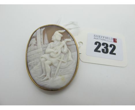 An Oval Shell Carved Cameo Brooch, depicting gentleman seated playing a mandolin, oval collet set. 