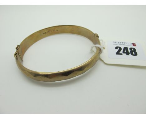 A 9ct Gold Hinged Bangle, (lacking safety chain / dents) (10.5grams). 