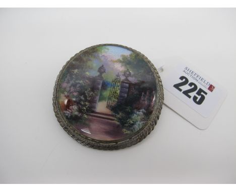 A Highly Decorative Circular Enamel Panel Brooch, depicting an ornate garden gate amongst flowers and foliage, circular colle