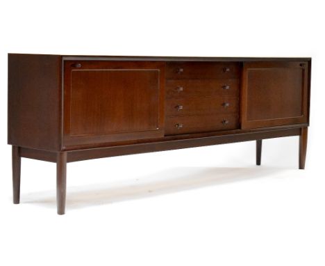 A retro Brahmin mahogany sideboard with four central drawers flanked by sliding doors, raised on stile supports, height 81cm,