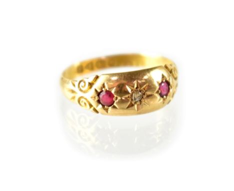 A 19th century hallmarked 18ct gold ring set with central diamond flanked by two red stones, size O, approx 2.1g. CONDITION R