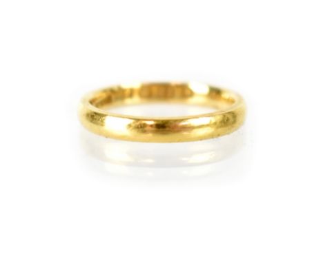 A 22ct gold wedding band, size K, stamped 22, maker's mark indistinct, Sheffield 1910. CONDITION REPORT Approx 3.4g.