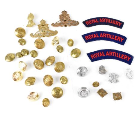 A group of Royal Artillery related items to include two badges and two shoulder flashes, buttons of varying sizes and a small
