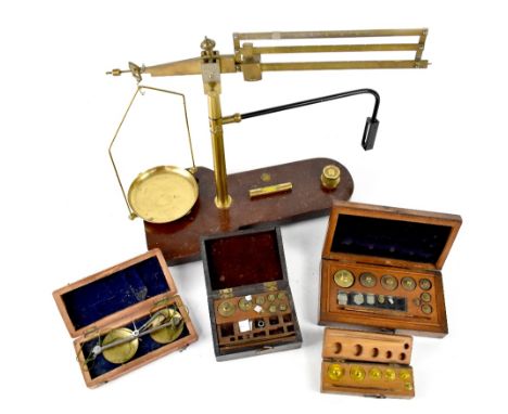 A Baird &amp; Tatlock London Ltd beam scale on a wooden base, with integral spirit level, length 37cm and four boxes containi