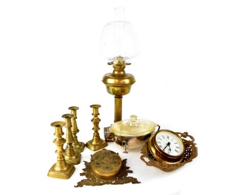 Various items of brassware to include a paraffin lamp with rippled clear glass shade, brass font raised on Corinthian column 