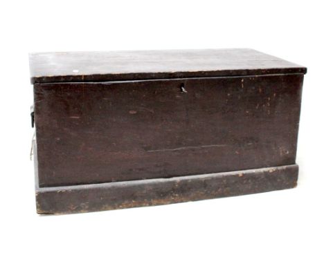 A 19th century stained pine sailor's trunk with black cast carrying handles to either side, length 102cm.