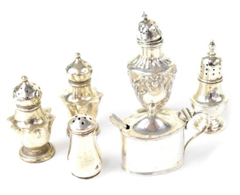 Various hallmarked silver pepperettes to include a pair of Edwardian examples, Birmingham 1906, one example with embossed flo