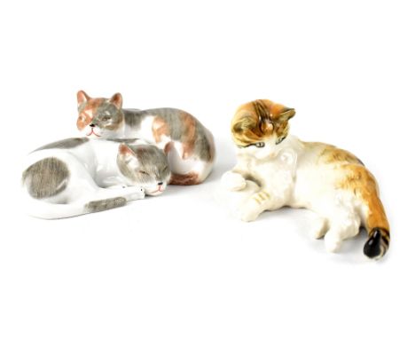 A Dresden animalia group of two reclining cats, marked to the base with a blue mark and Dresden and a reclining kitten playin