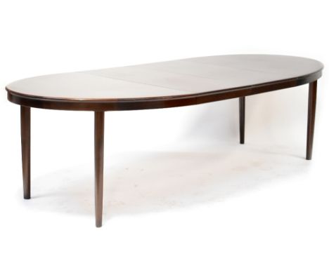 A retro Brahmin mahogany crossbanded oval extending dining table with two additional leaves, raised on rounded triangular tap