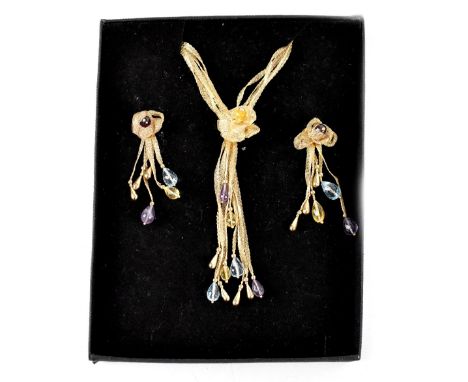 A yellow metal necklace and drop earring set, five strands of spun yellow metal suspending a floral and tassel pendant with a