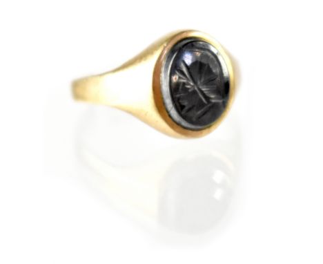A 9ct gold gentlemen's ring with an intaglio in the form of a gladiator's head, size K, approx 2.6g. CONDITION REPORT The sha