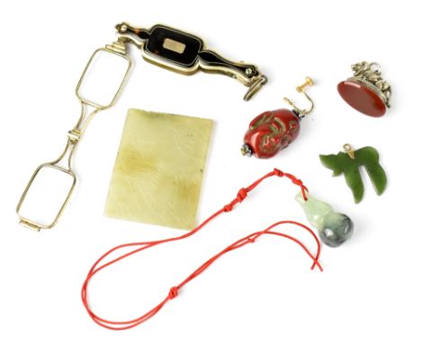 A small thin hardstone plaque etched with an Oriental landscape design, two Oriental jade-style pendants, a single earring wi
