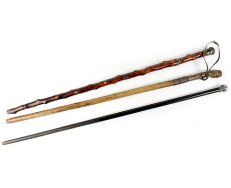 A Howell of London early 20th century sword stick walking cane with white metal handle cap, a 19th century sword stick walkin