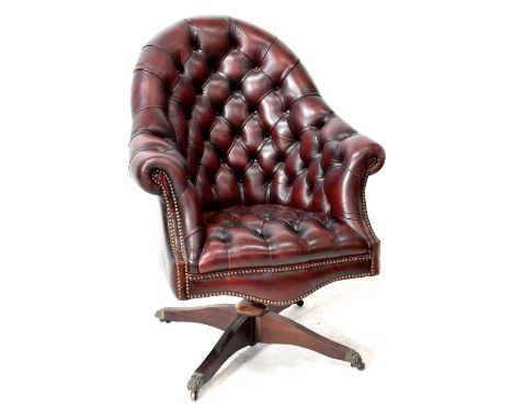 A modern red leather studded button back office chair on a swivel quadripartite base with castors. CONDITION REPORT Minor scu