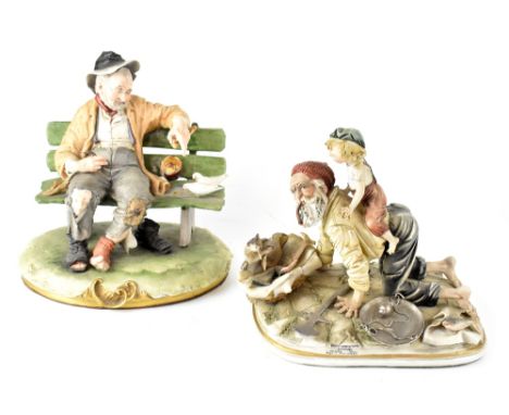 A Capodimonte figural group, an old fisherman playing with a young boy, with metallic highlighted sections, 20 x 24cm, and a 
