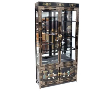 A modern Chinese black lacquer and Chinoiserie decorated display cabinet with a pair of glazed doors enclosing an illuminated