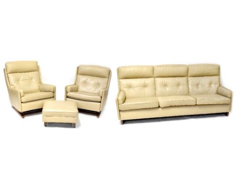 A 1960s three-piece suite comprising a three-seat settee, length 214cm, a pair of rocking chairs and matching footstool, butt