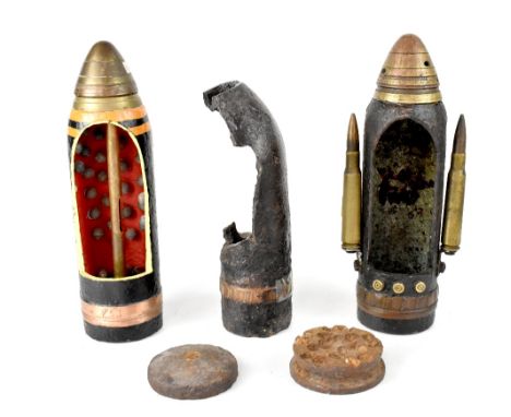 Two ballistic artillery shells with mechanical timer, with cut-away front sections, one to show the inner workings, the other