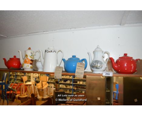 *SHELF OF MIXED PORCELAIN WARES, MAINLY TEA/COFFEE POTS