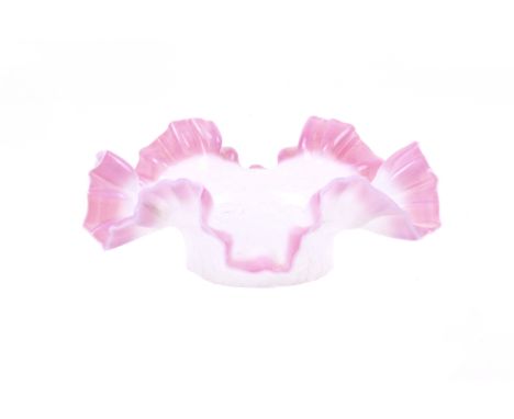 An Edwardian vaseline glass lamp shade. Having a pink frilled edge, 16cm diameter