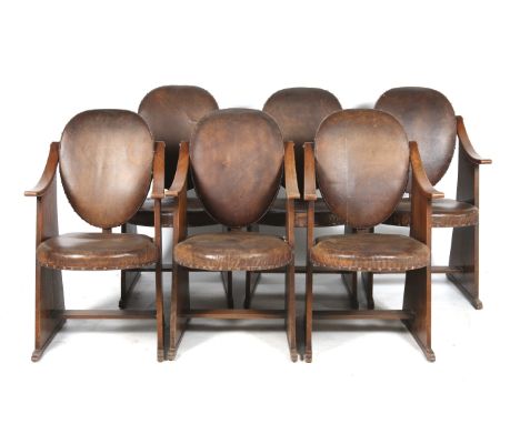 A set of six 20th century Liberty & Co chairs. Circa. 1935, the oak frames having swept armrests and plank sides united by a 