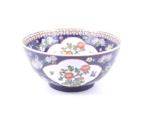 A Chinese Qing dynasty enamelled porcelain basin. With polychrome enamel friezes with blooming peony and insect cartouches to