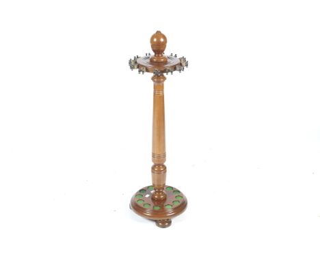 A contemporary floor standing snooker cue stand rack. With a turned column and finial, spaces for twelve cues, raised on a ci