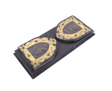 A 19th century coromandel veneered book slide. The ends having brass bindings, each surrounding an arched cartouche, each wit