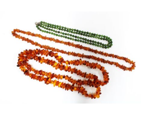 Two strands of amber beads and a double strand of jade beads, (3) 