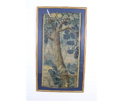 An Antique tapestry showing a camp in a forest, framed under glass, 112 x 60cm 