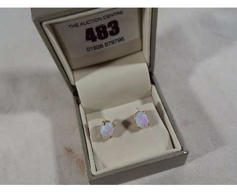 A pair of 9 ct gold stud earrings stamped 375 set with opal